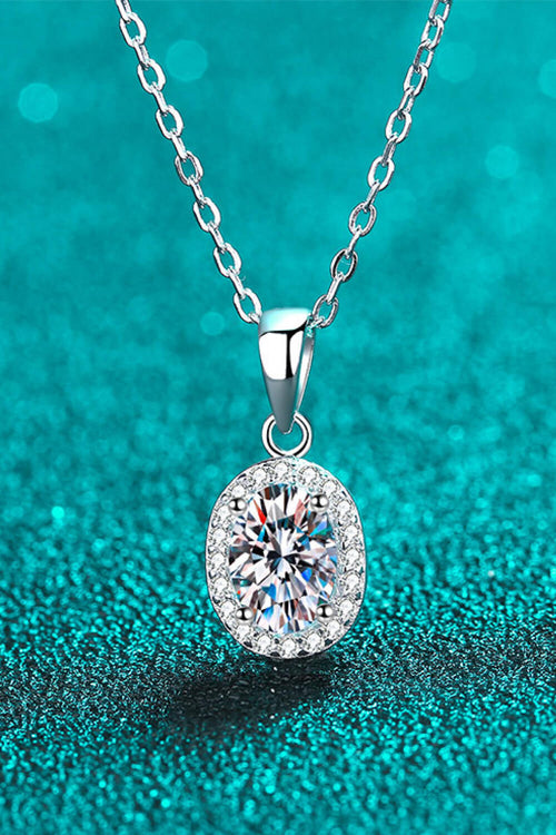 Silver moissanite pendant necklace with oval stone and halo, on chain