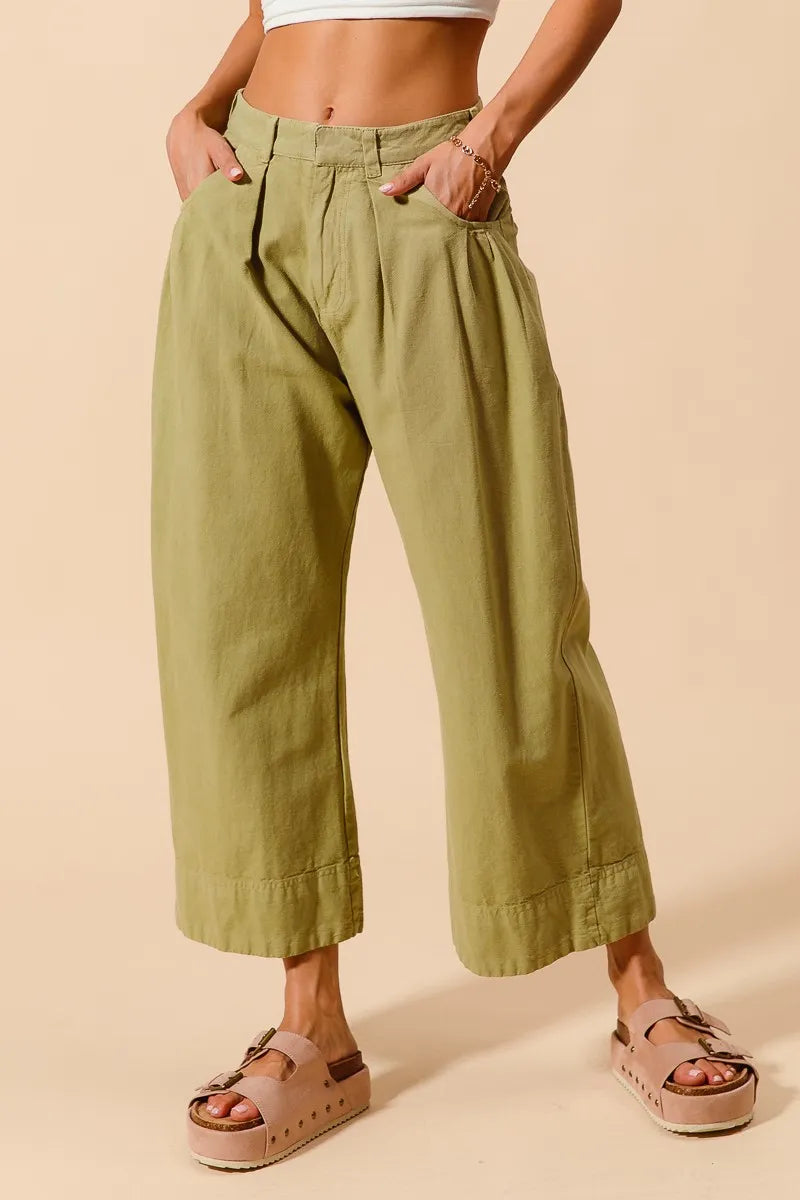 Sage green mid-rise wide-leg chino pants with side pockets and roomy legs