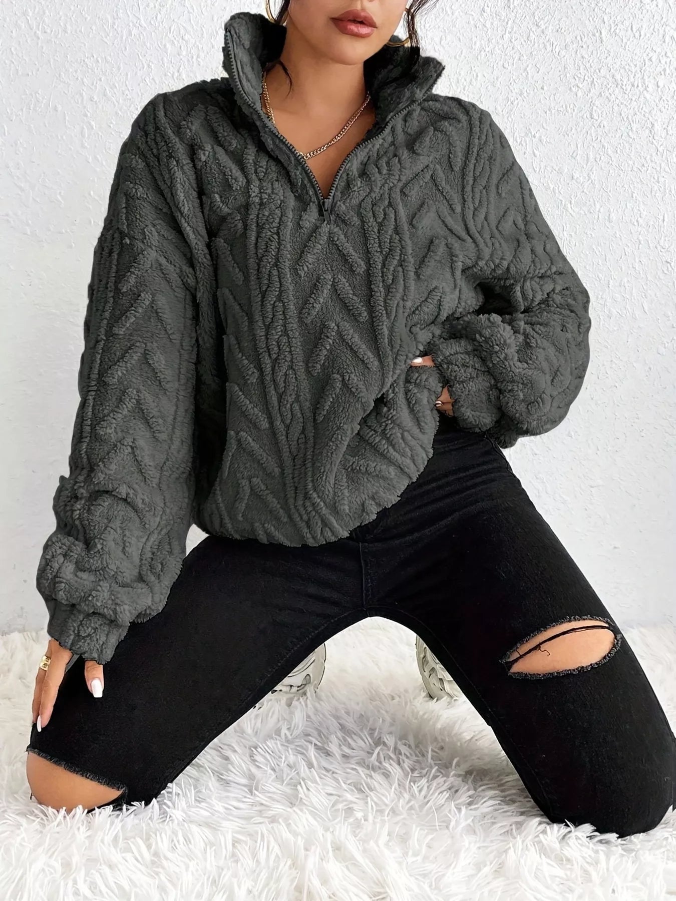 Dark gray sherpa quarter-zip sweatshirt with cable-knit texture and dropped shoulders