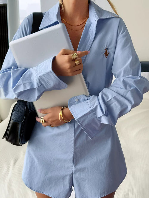 Light blue button-front long sleeve romper, pointed collar, chest emblem