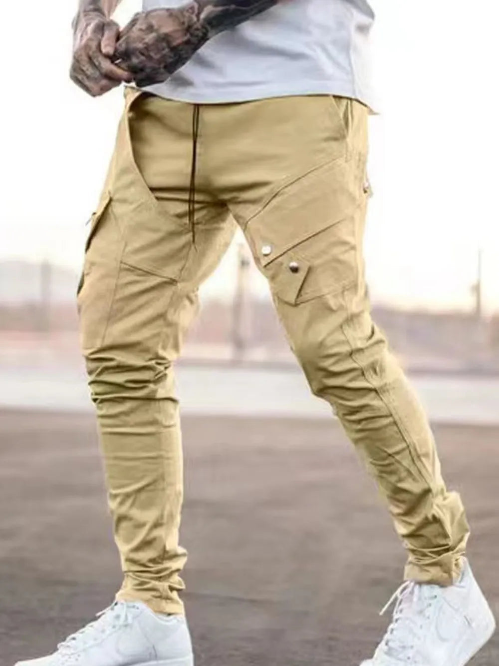Men's plus size cargo pants in tan with side cargo pockets and metal buttons