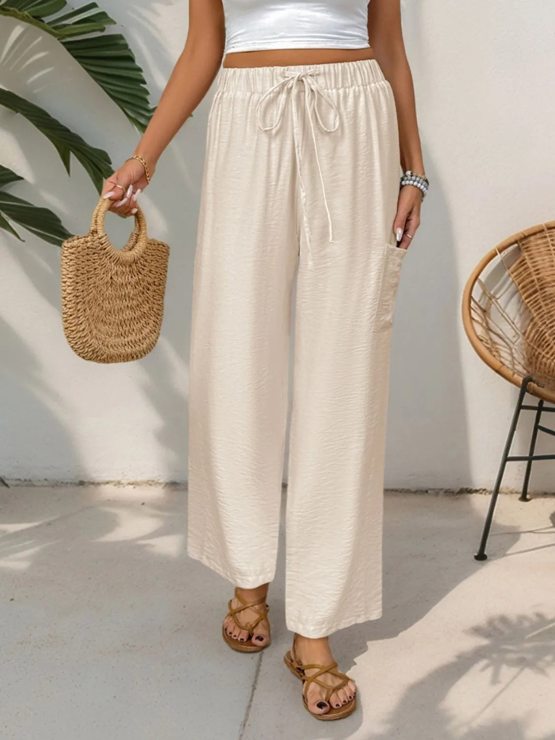 Cream drawstring wide-leg pants with elastic waistband and wide, ankle-length legs