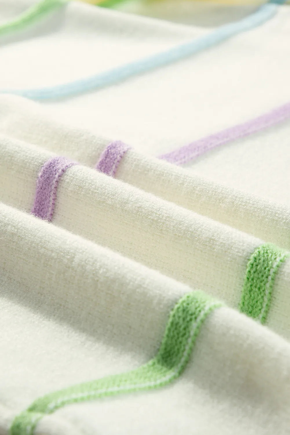 Ivory knit fabric with pastel stripe accents in green, blue, and purple, soft ribbed texture