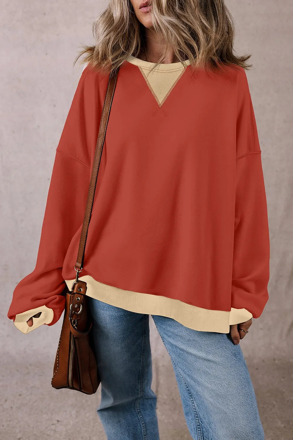 Rust red long-sleeve sweatshirt with V-contrast yoke and ribbed light cuffs