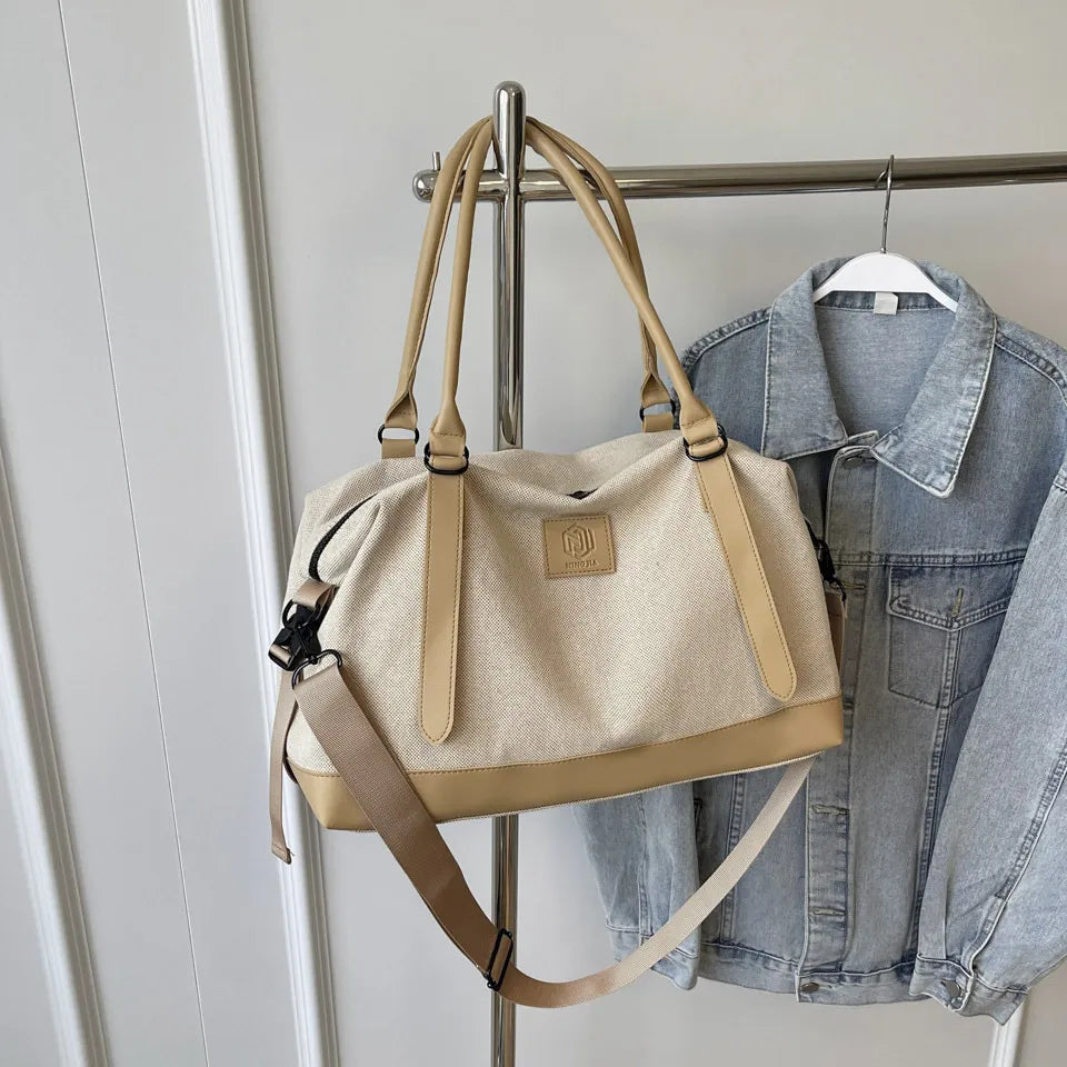 Large polyester duffle bag in beige with tan contrast handles and shoulder strap