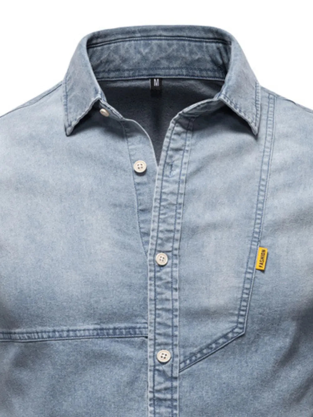 Light blue denim button-down shirt close-up with pointed collar, button placket, chest pocket