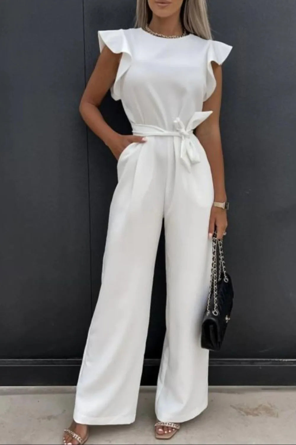 White round-neck cap-sleeve jumpsuit with waist tie and wide-leg silhouette