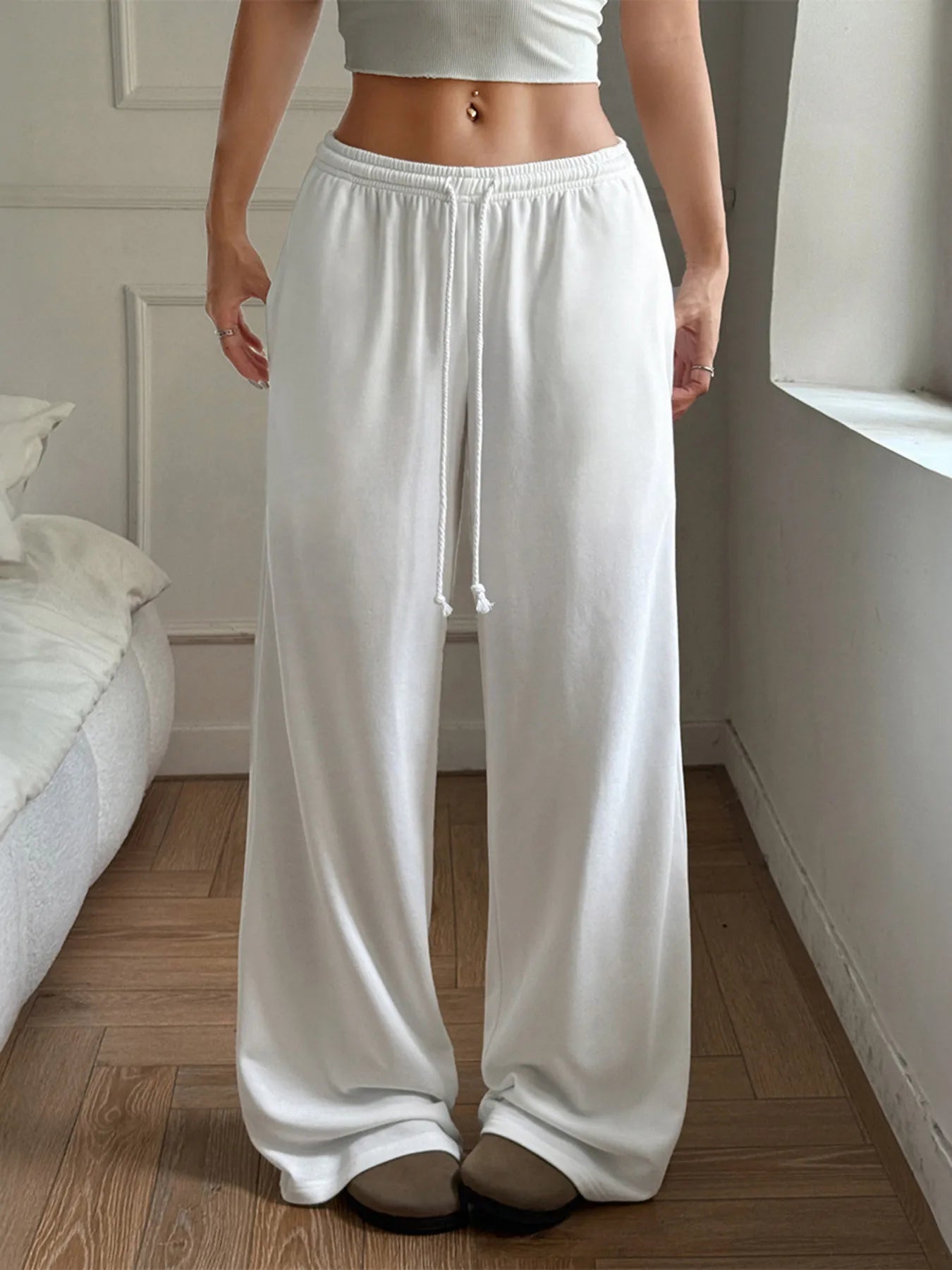 White relaxed wide-leg drawstring pants with draped legs and gathered elastic waistband