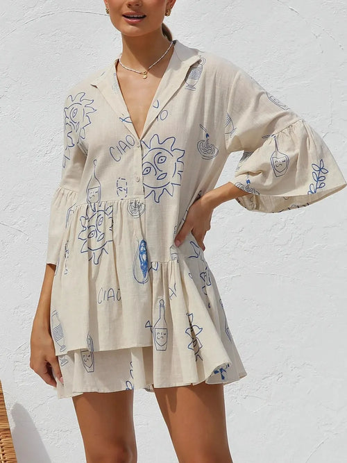 Cream printed mini dress with blue doodles, button-front V-neck, and flared skirt