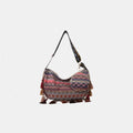 Printed hobo-style crossbody bag with tassel trim and small matching coin pouch.