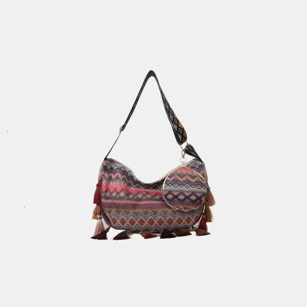 Printed hobo-style crossbody bag with tassel trim and small matching coin pouch.