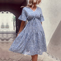 Light blue floral v-neck dress with waist tie and tiered, full skirt