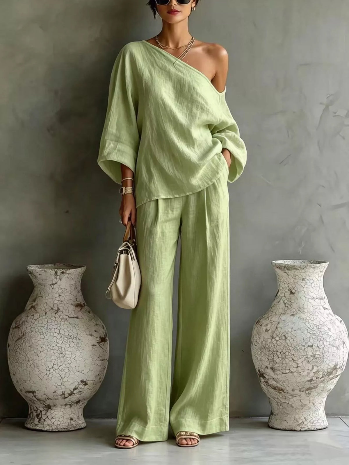 Lime green one-shoulder drape top with wide-leg matching pants set.
