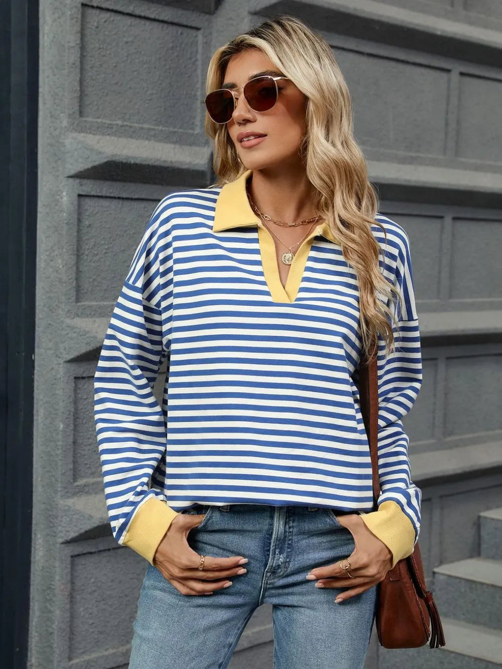Front view of navy and white striped long-sleeve sweatshirt with tan cuffs and collar