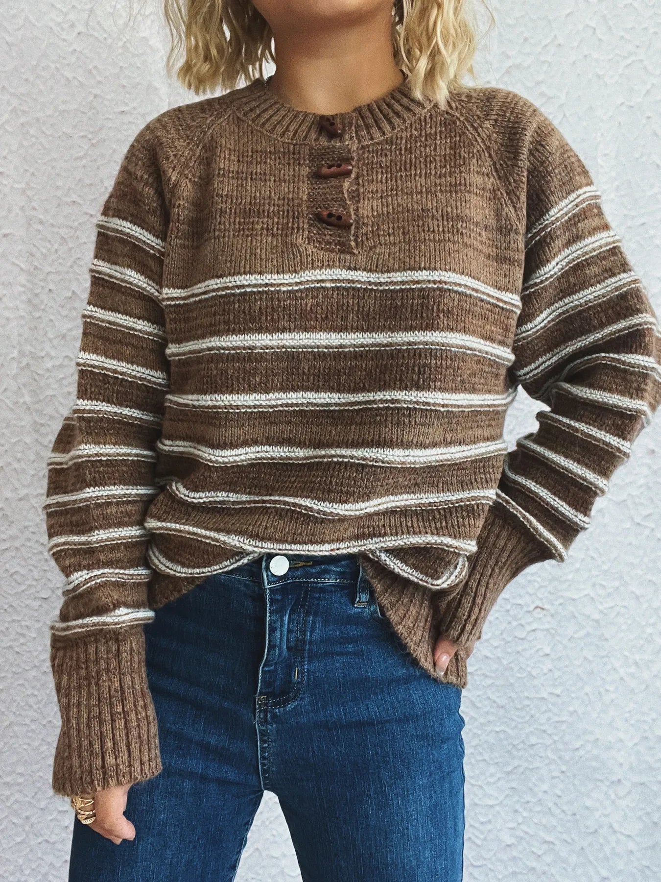 Brown striped long sleeve sweater with button detail at crew neckline