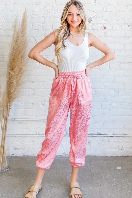 Pink satin leopard print joggers with elastic waistband and drawstring
