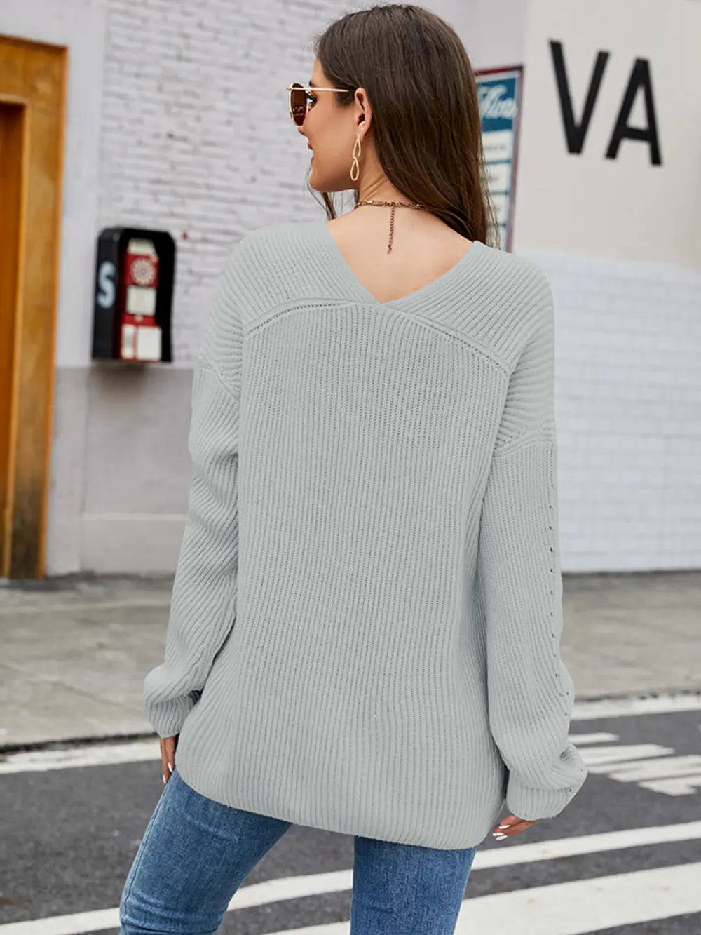 Light blue long sleeve sweater, back view, dropped shoulders with ribbed cuffs and hem