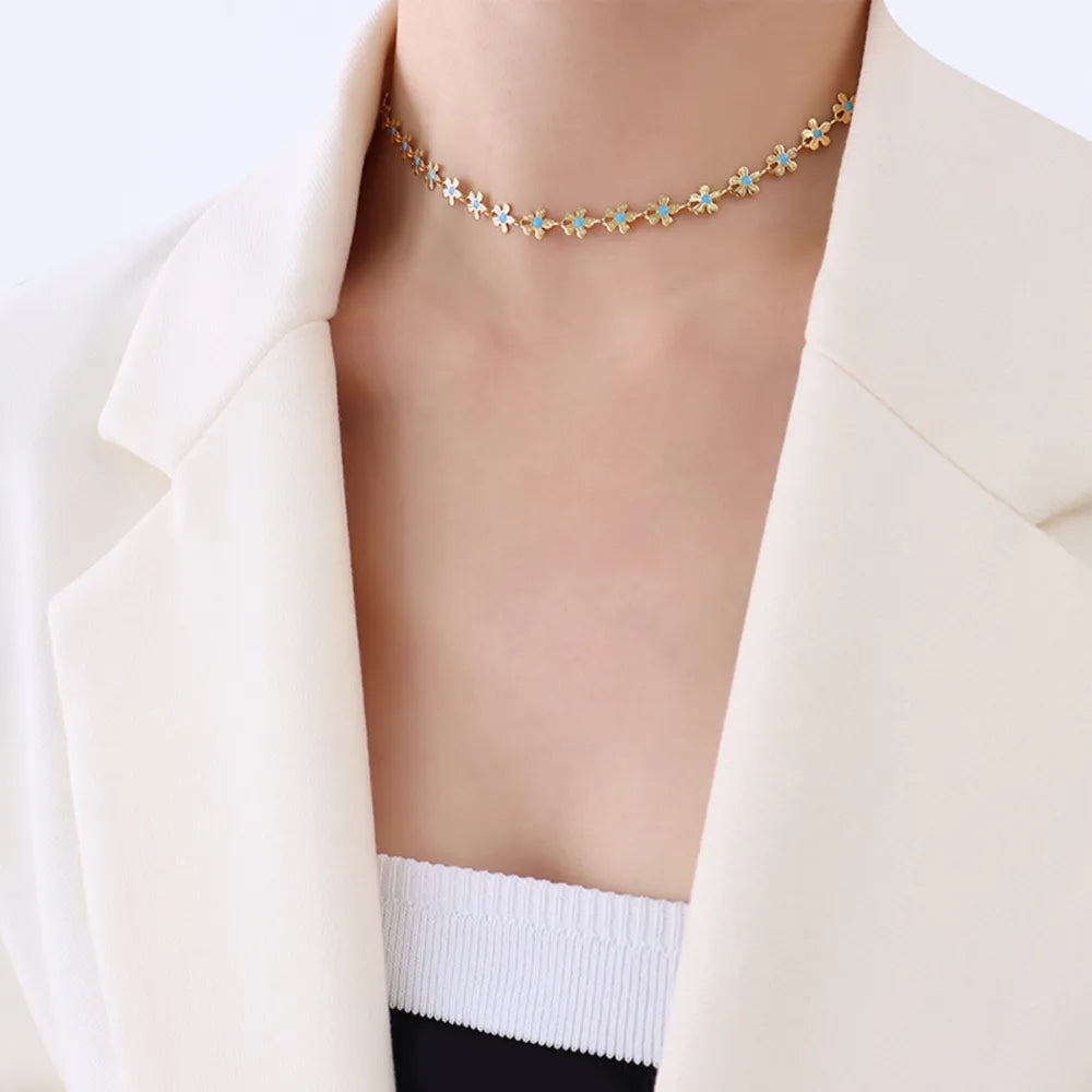 Gold-tone choker-style necklace with blue flower clover beads across neckline