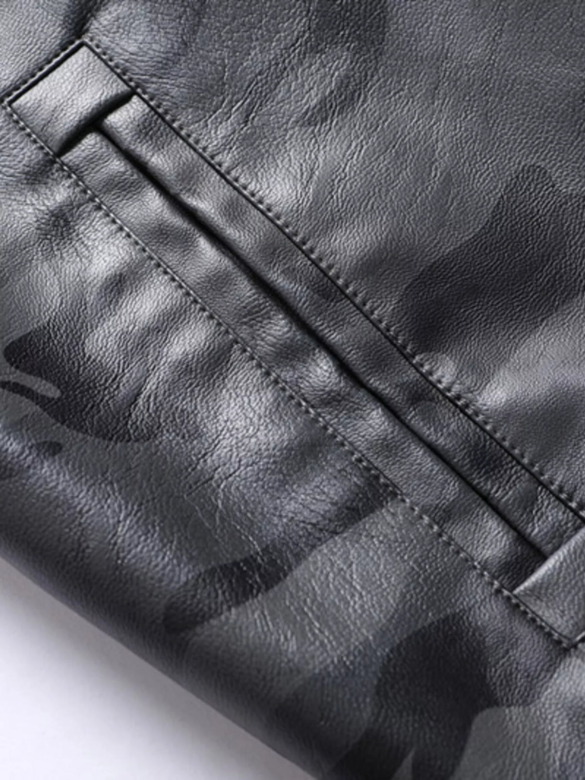 Vegan leather jacket sleeve panel with stitched flap and hidden pocket seam