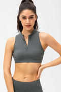 Dark gray cropped active tank top with sleeveless design and front half-zip closure