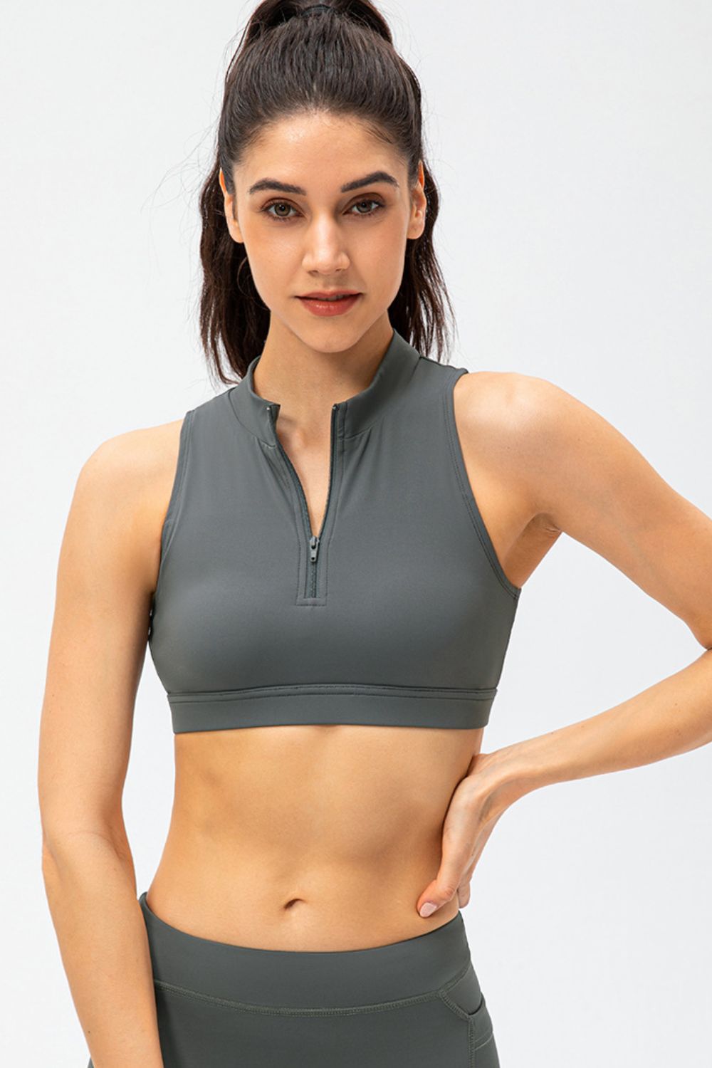 Dark gray cropped active tank top with sleeveless design and front half-zip closure