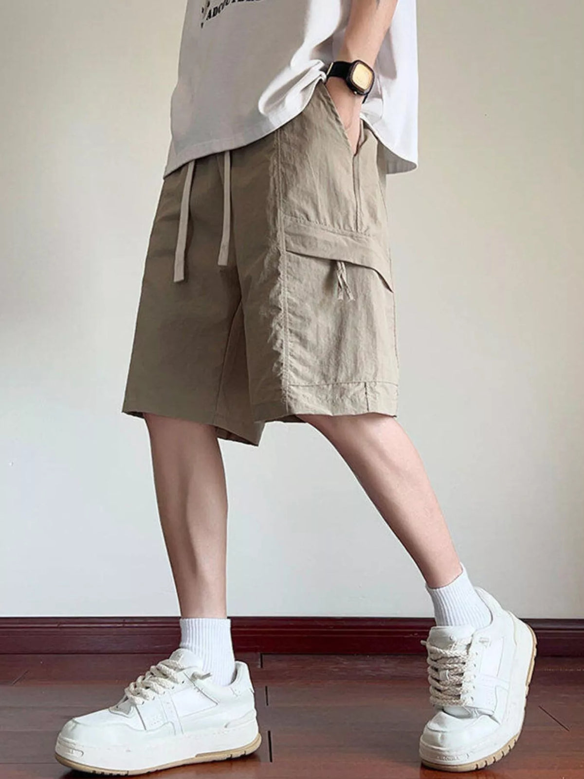 Men's khaki cargo shorts with drawstring waist and utility side pockets
