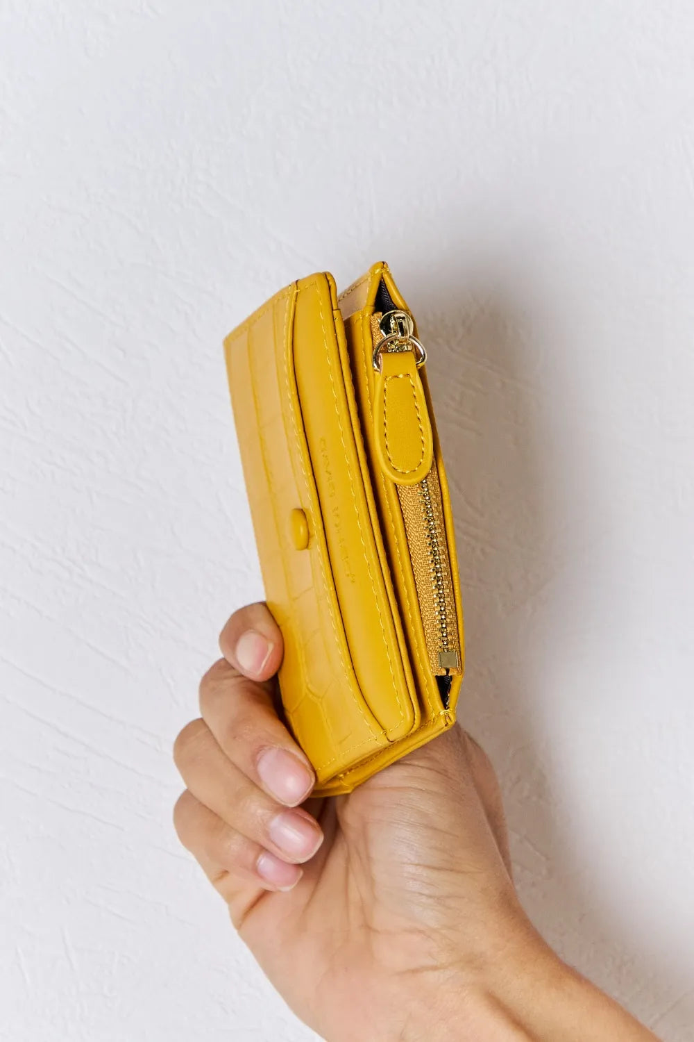 Yellow textured vegan leather mini wallet side view with gold-tone zipper and tab