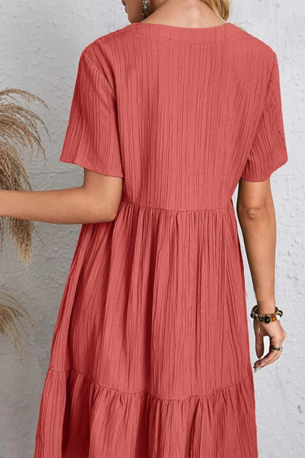 Back view coral ruched V-neck short-sleeve tiered dress with gathered waist