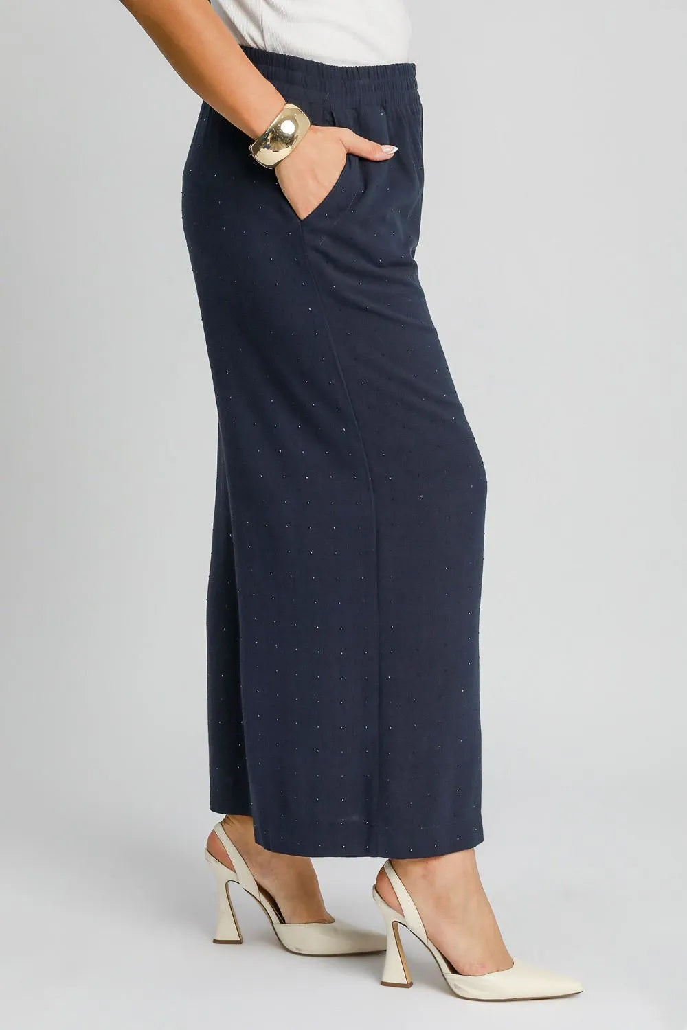 High-waisted dark blue wide-leg pants with elastic waist and speckled texture
