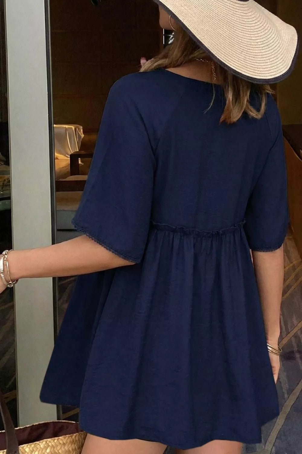 Ruffle Hem Tie Neck Blouse in navy by Trendsi, featuring buttoned and tied details