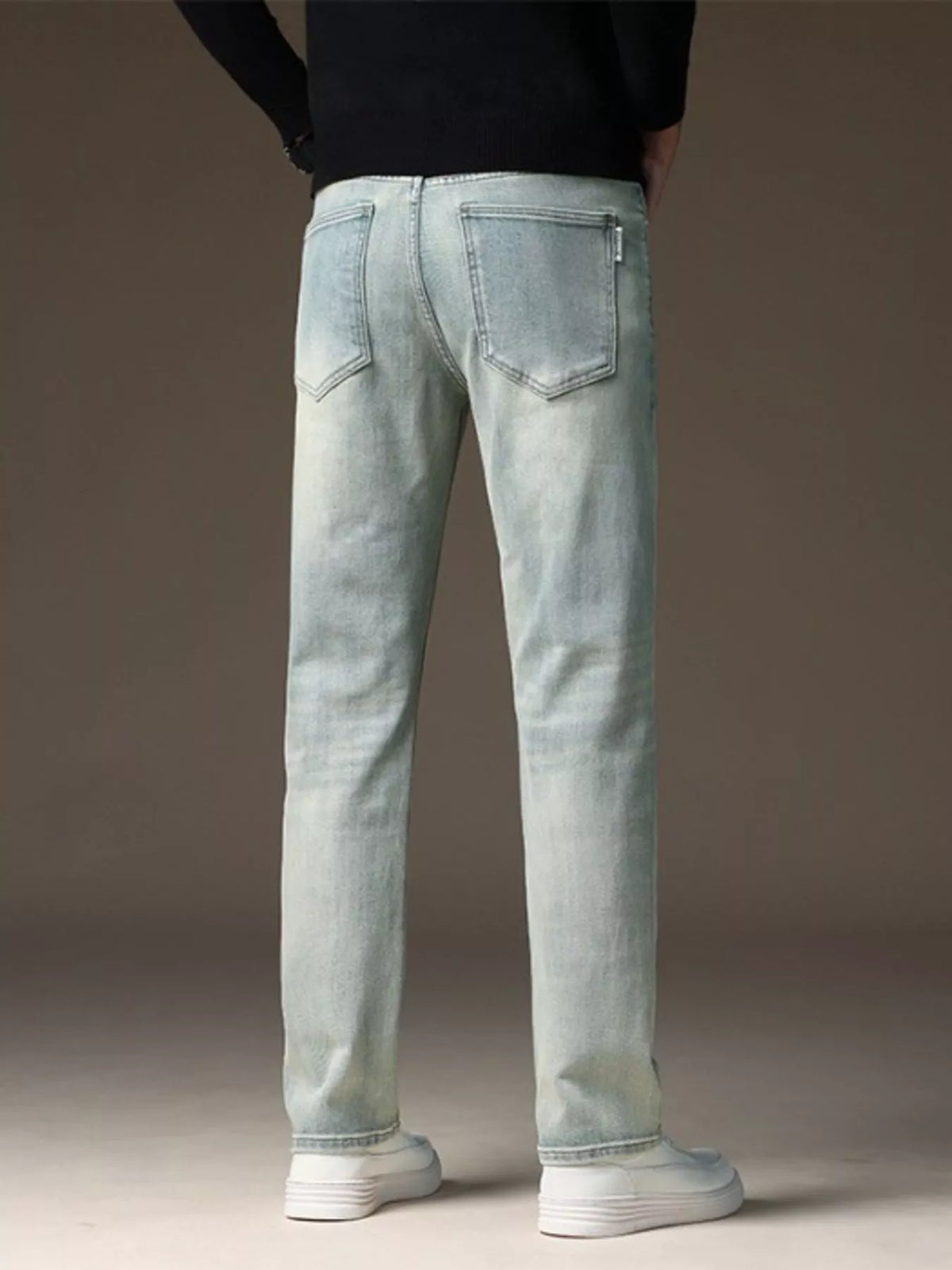 Light wash straight-leg jeans, back view with two patch pockets