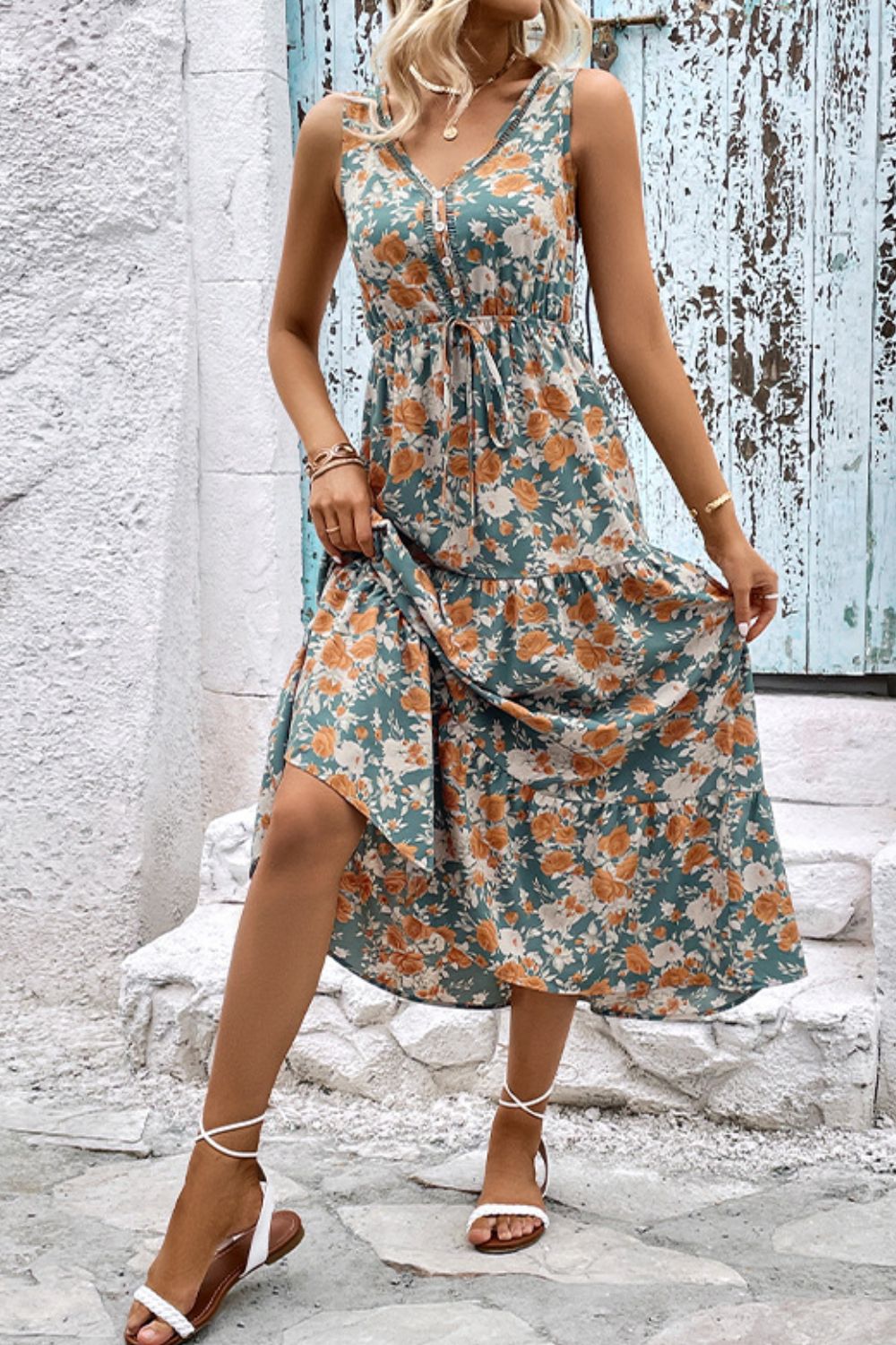 Floral V-neck tiered sleeveless midi dress with layered skirt, orange and teal print.