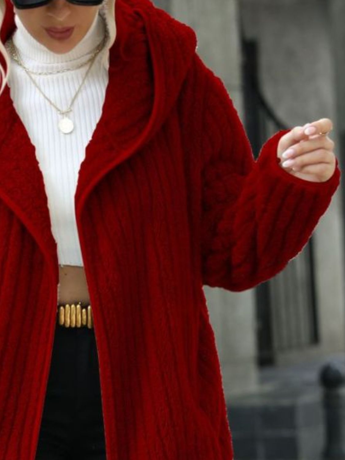 Wine red ribbed hooded open-front coat detail, showing textured knit and clasp