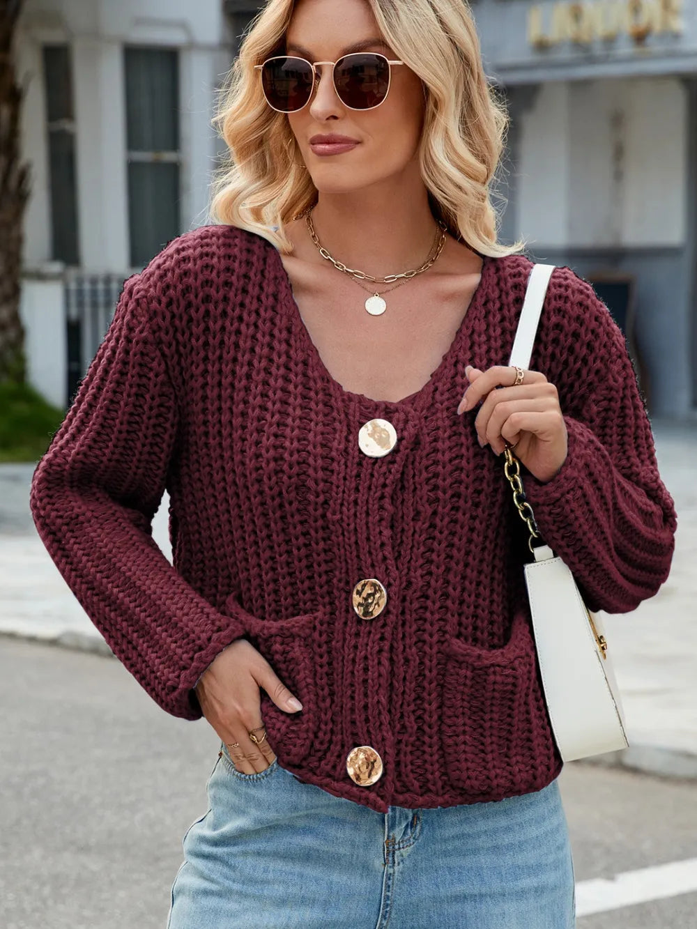 Burgundy round-neck cardigan with patch pockets and gold button front, long sleeves
