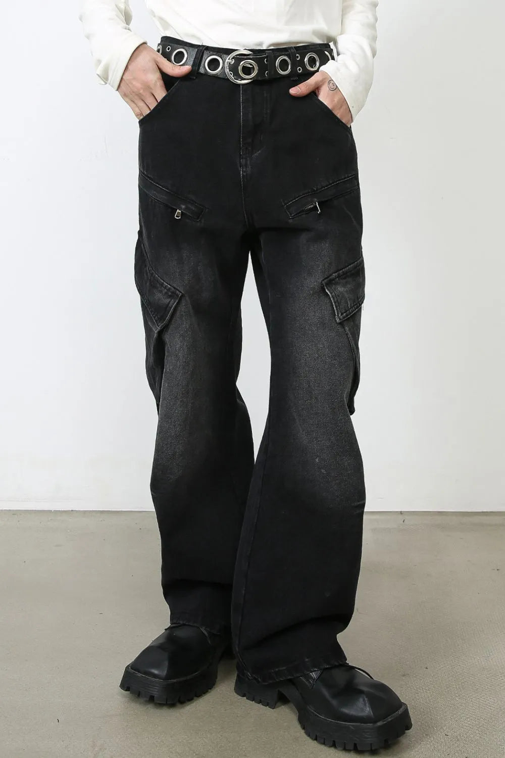 Dark baggy cargo jeans with two front cargo flap pockets and wide legs