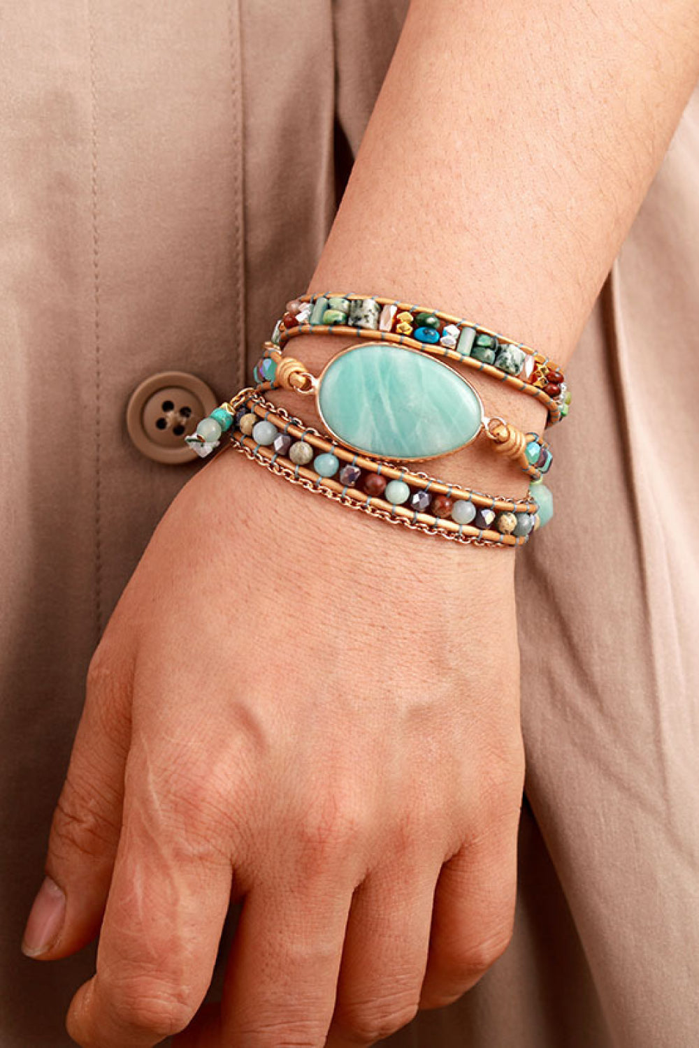 Triple-layer beaded bracelet with aqua oval stone centerpiece and gold-tone chain accents