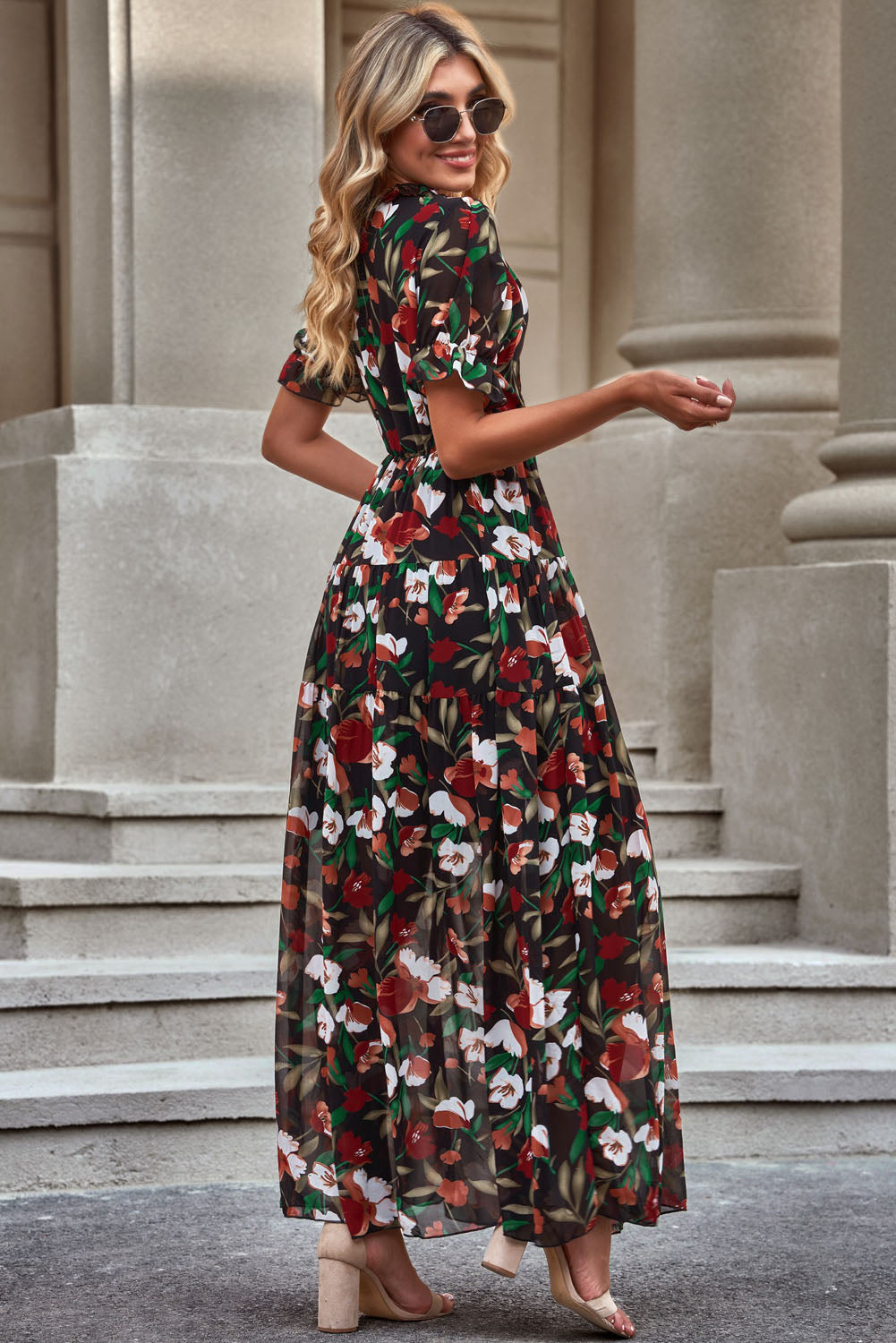 Floral V-neck short flounce sleeve dress with tiered skirt, black base and white flowers.