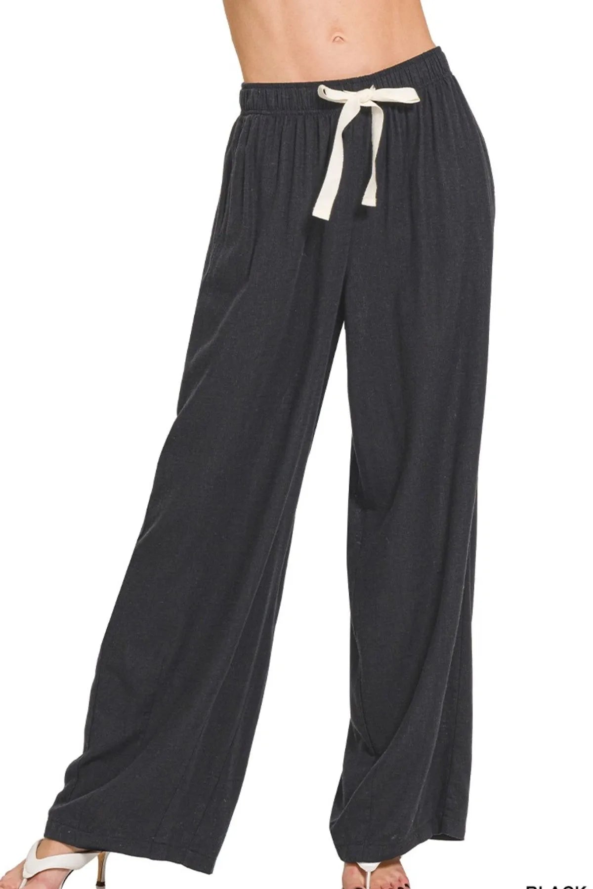 Black linen drawstring pants with elastic waistband and wide-leg fit