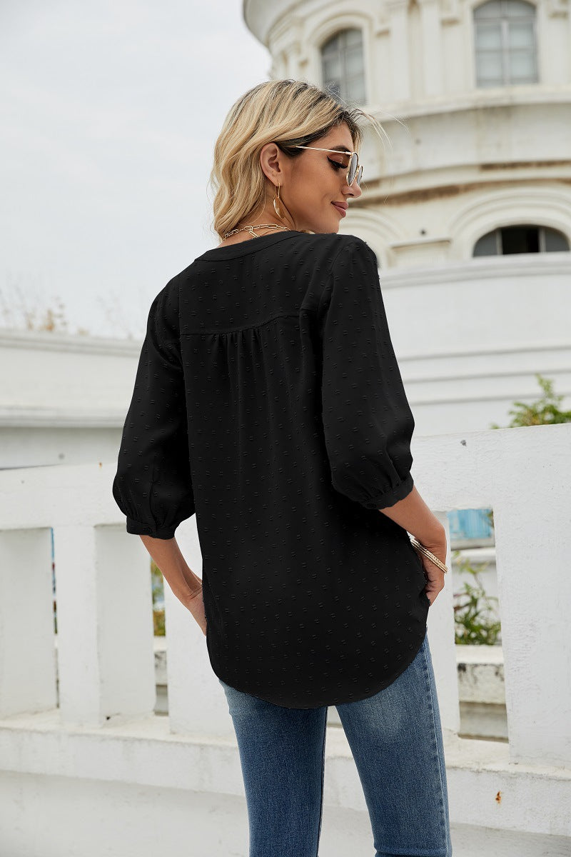 Black Swiss-dot notched-neck blouse with 3/4 puff sleeves and button placket