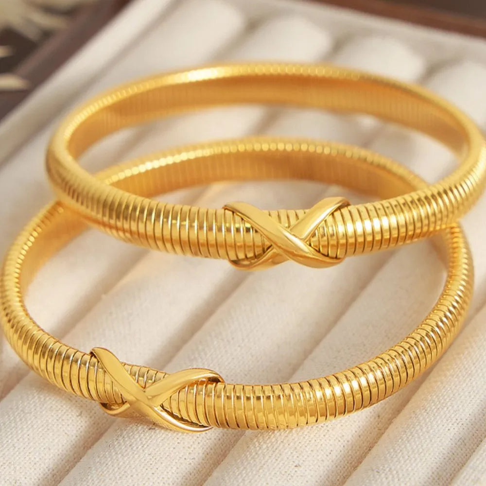 Gold spring coil bracelet with two twisted knot details