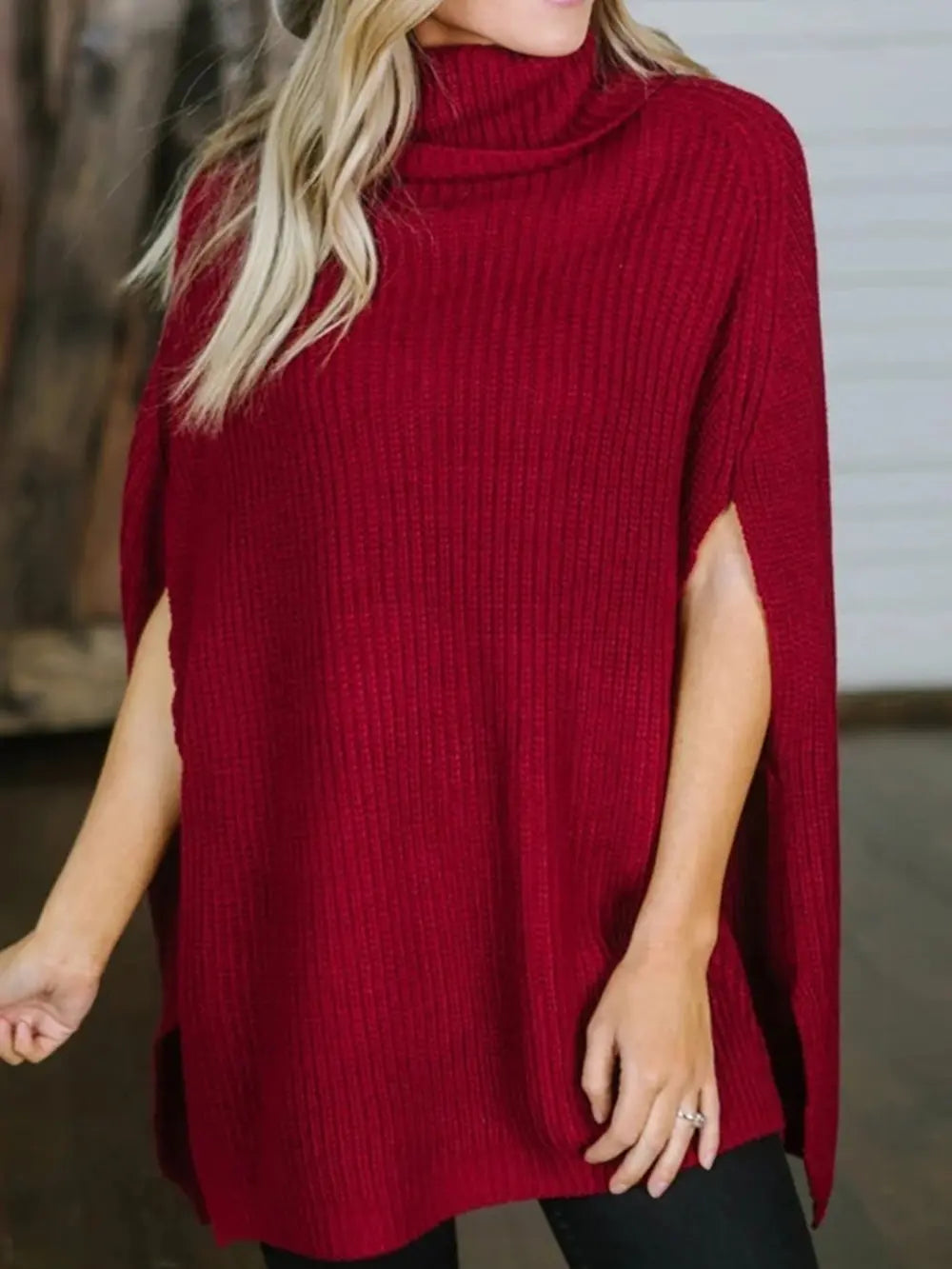 Burgundy turtleneck slit sweater, ribbed texture, side slit and poncho-like drape.