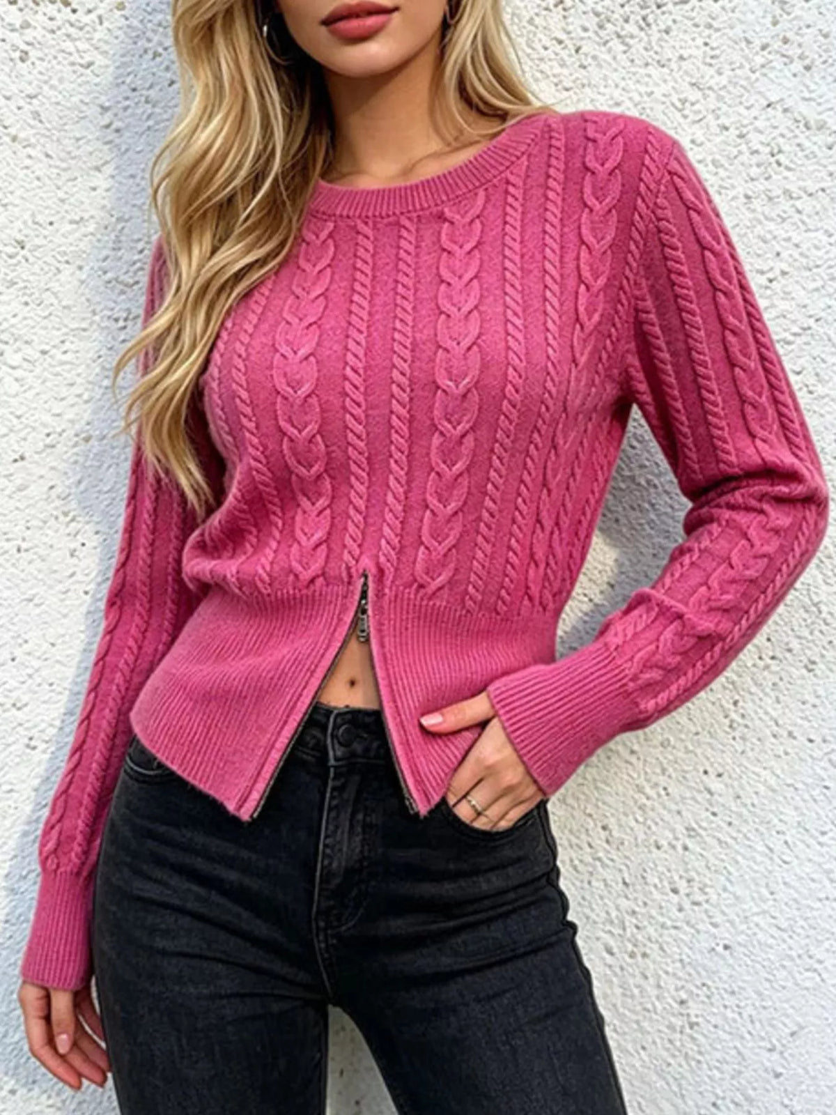 Hot pink cable knit zipper sweater with long sleeves and ribbed cuffs, worn with jeans