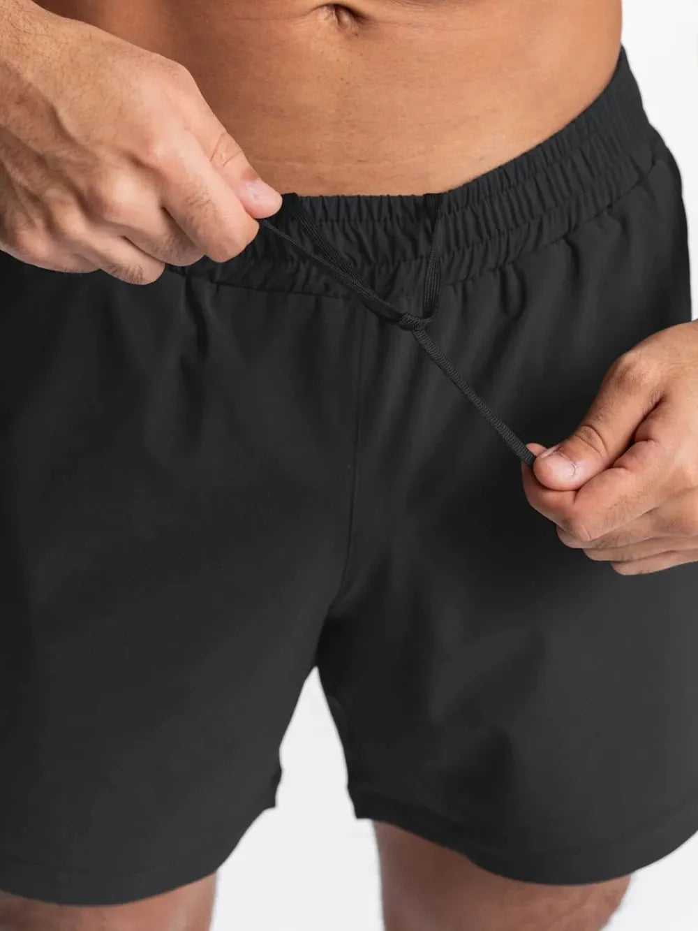 Men's elastic-waist active shorts in black, with elastic waistband and drawstring.