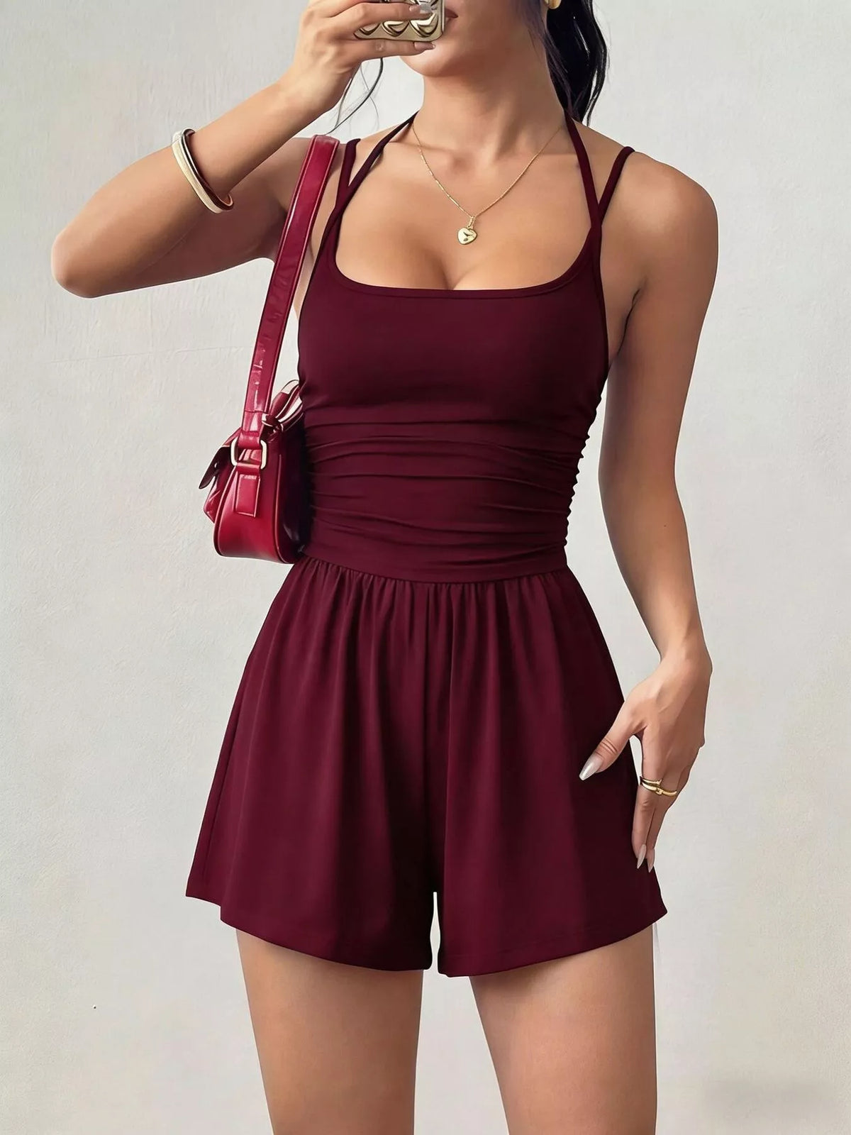 Wine red sleeveless ruched spaghetti strap romper with ruched front and swing shorts