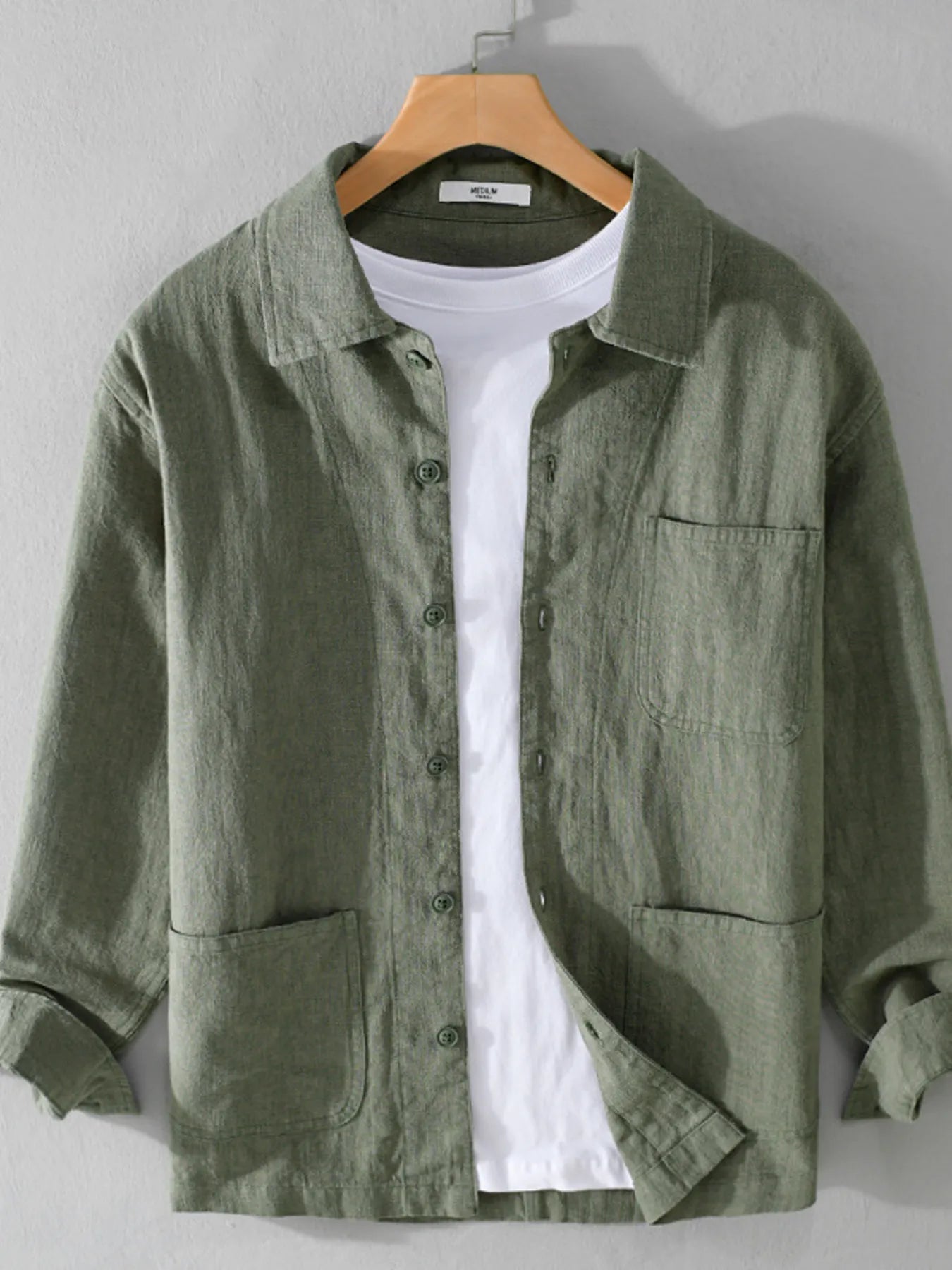 Green button-up shirt with chest pocket, button front, and long sleeves.
