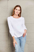 White off-shoulder rib-knit sweater, long sleeves and wide neckline.