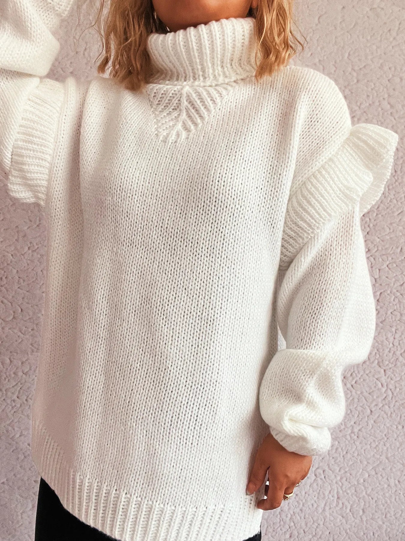Cream white ruffled turtleneck sweater with cable knit detail and cuffs