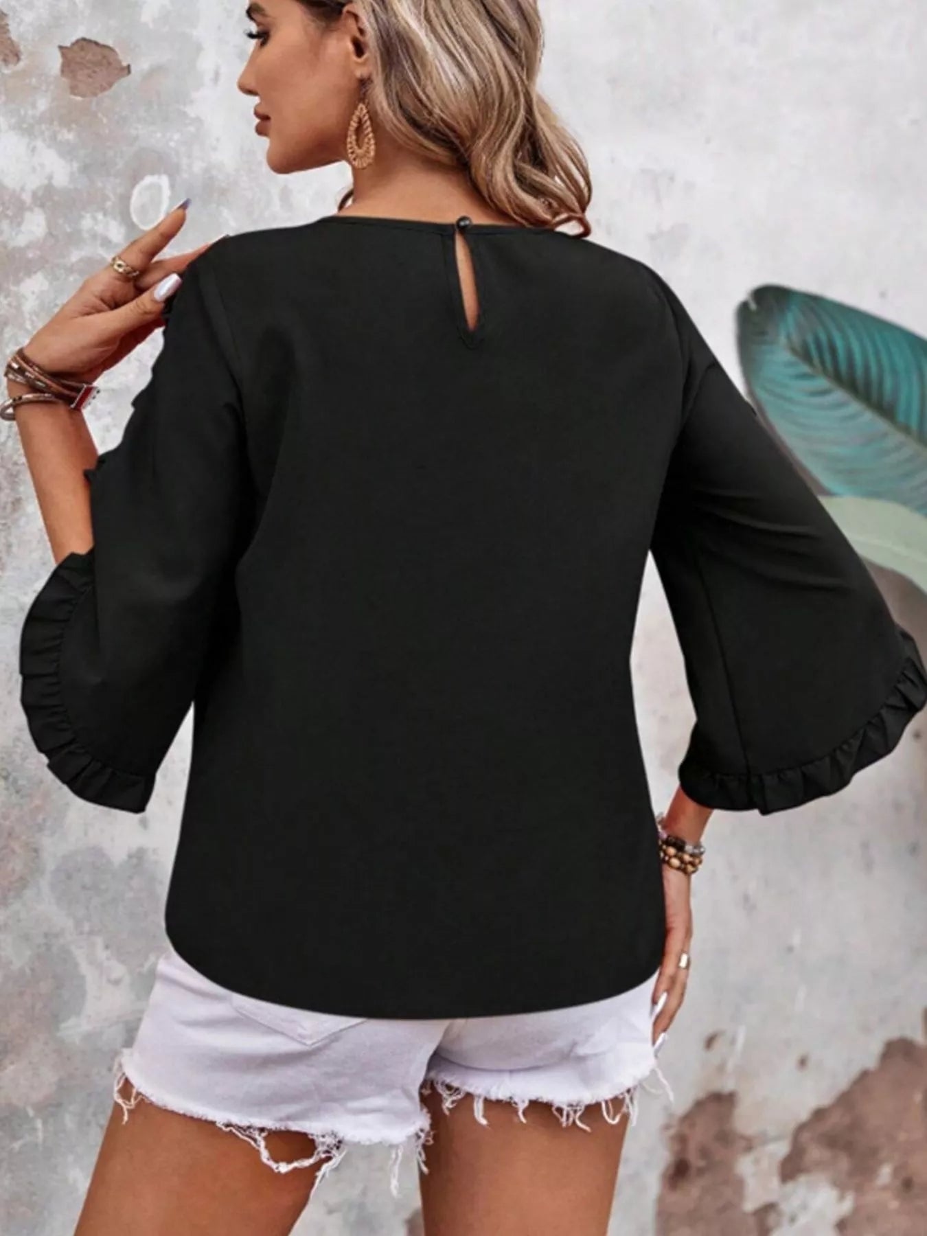 Ruffle-sleeve black blouse with back keyhole and button detail
