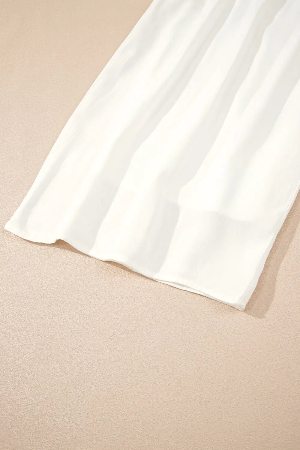 White wide-leg pants with wide hem and flowing drape