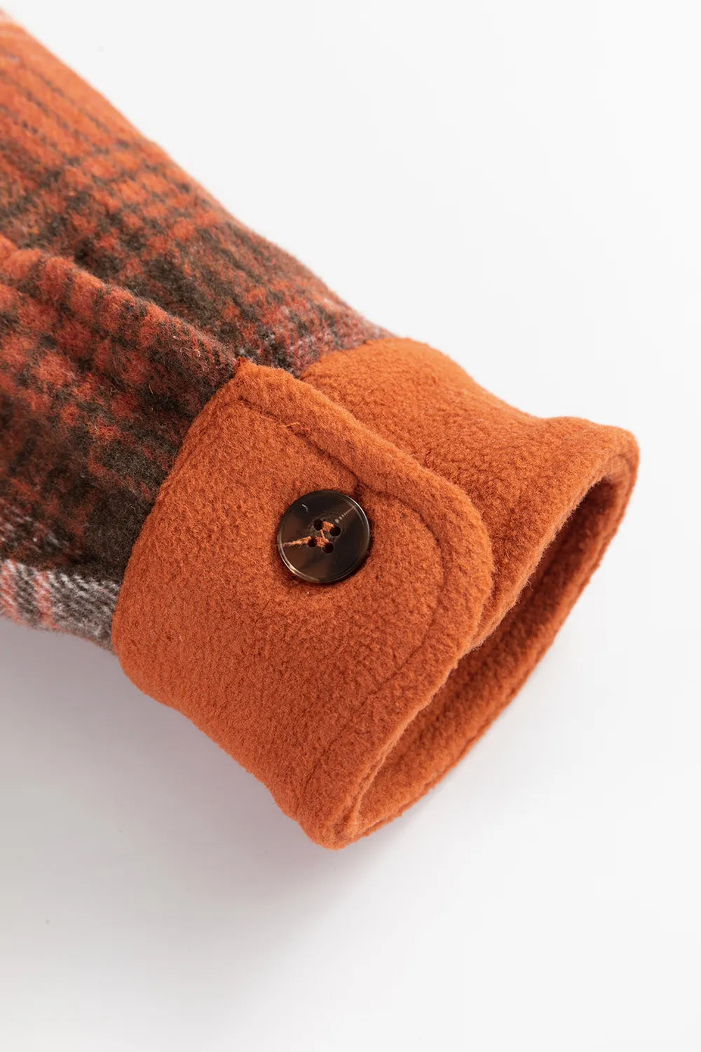 Plaid button-up long sleeve jacket sleeve cuff detail with black button and rust orange trim